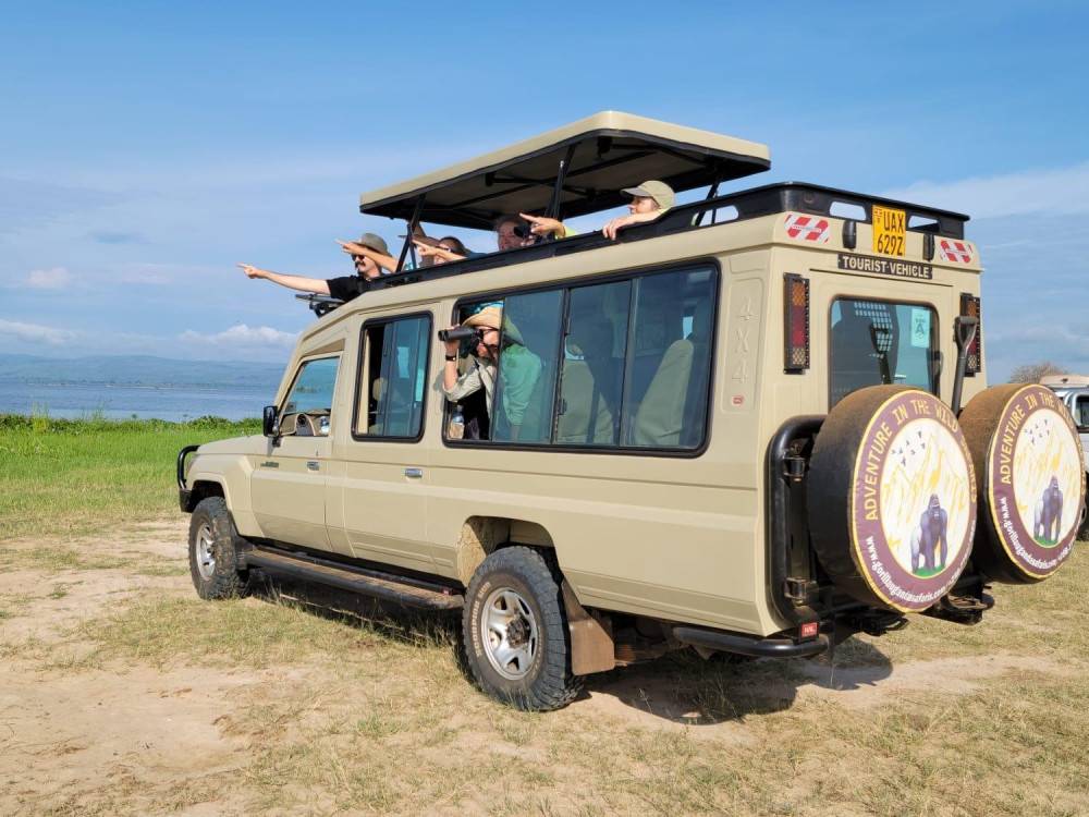 Adventure in the Wild Safaris 4×4 safari vehicle with pop-up roof for game viewing in Uganda.